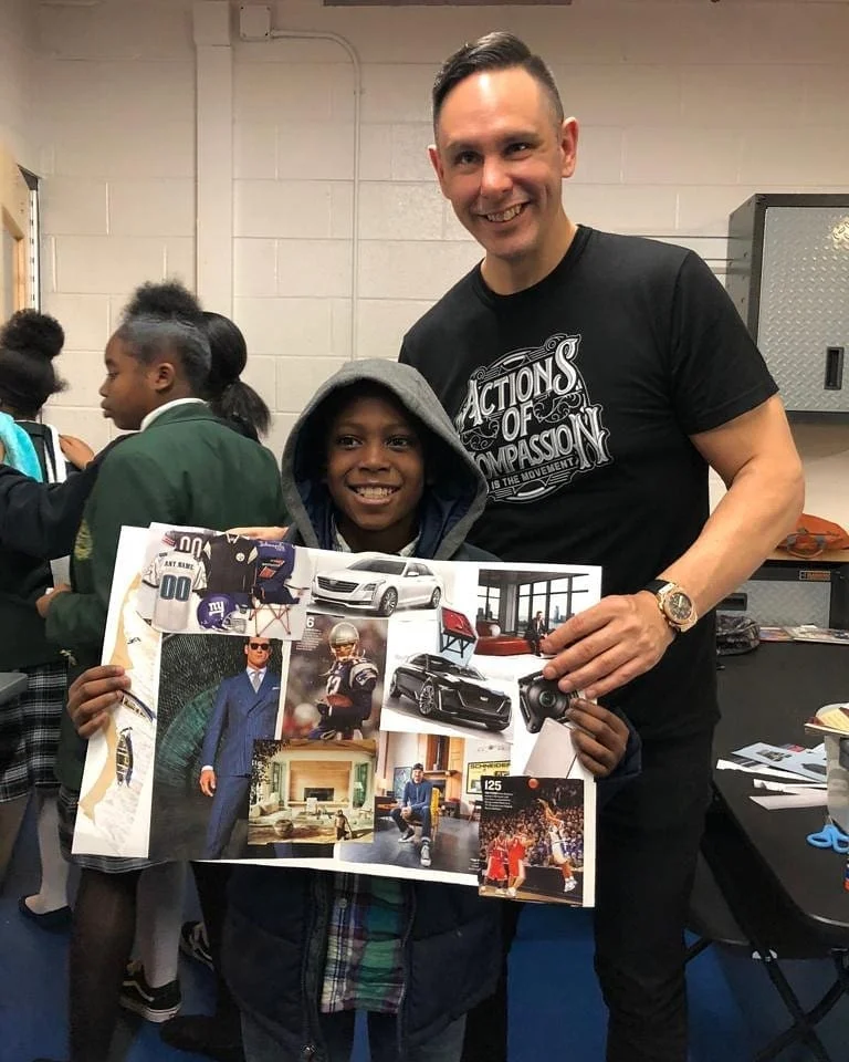 Shane James beside a student holding up the vision board he built at an Actions of Compassion workshop